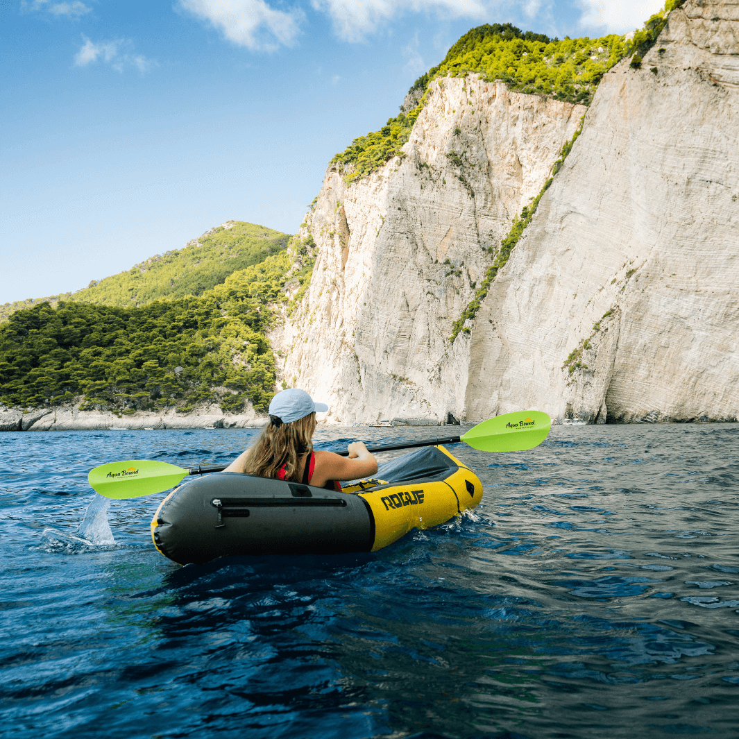 manta ray fiberglass 4-piece snap button electric green being paddled in packraft#color_electric-green