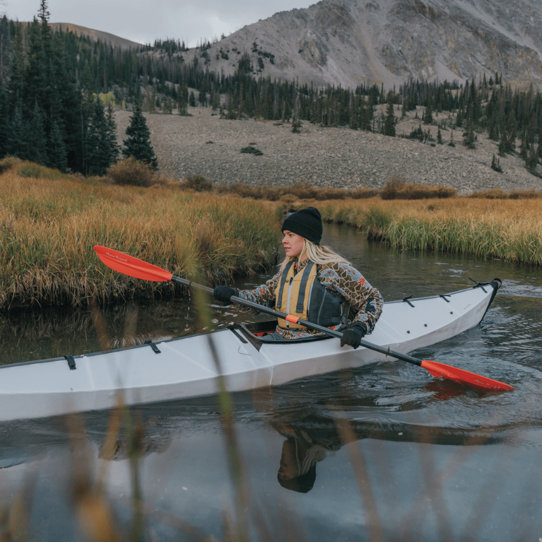 sting ray hybrid 2-piece posi-lok sunset red being paddled by blonde woman#color_sunset-red