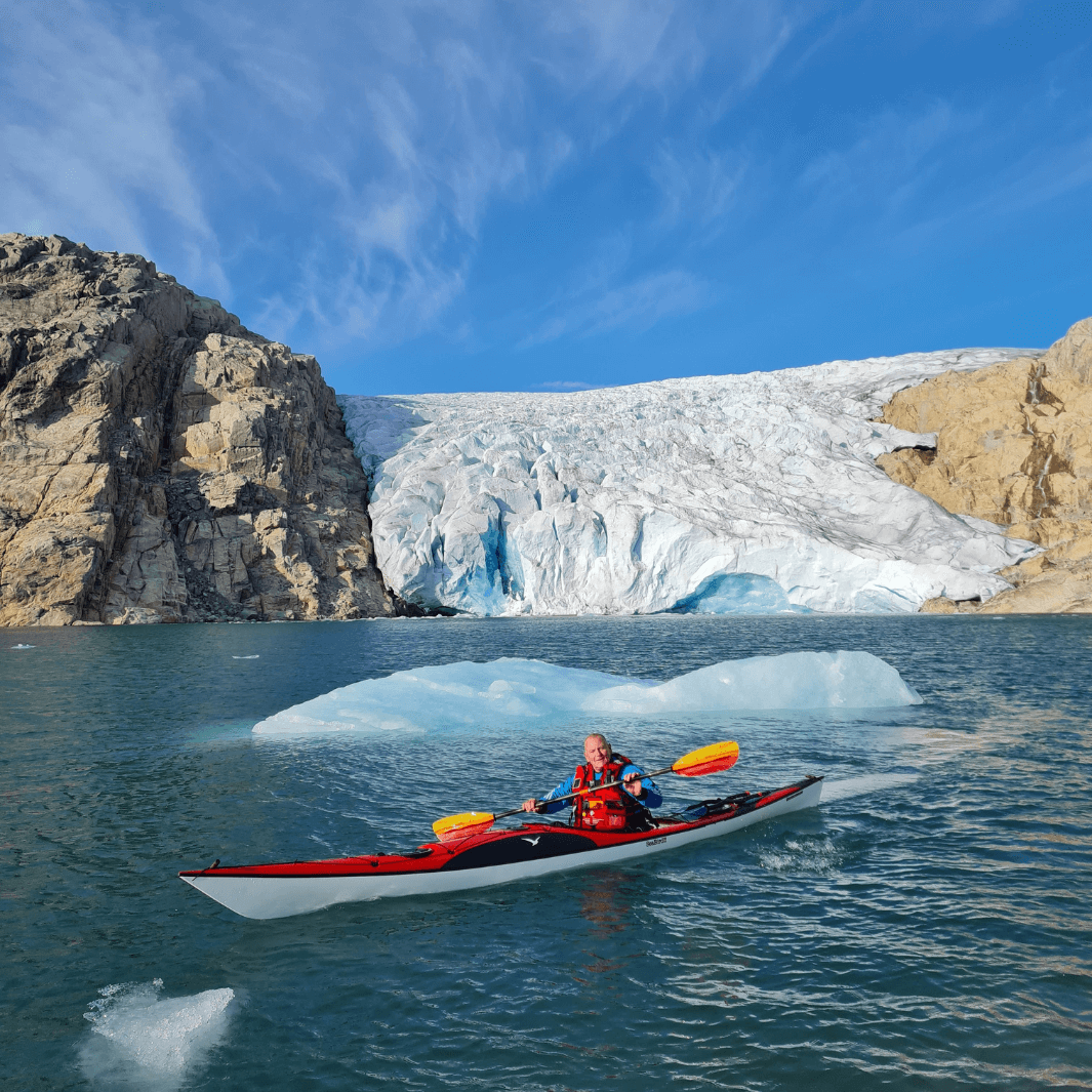 tango fiberglass bent shaft kayak paddle fuego being paddled in glacial waters in Norway #color_fuego