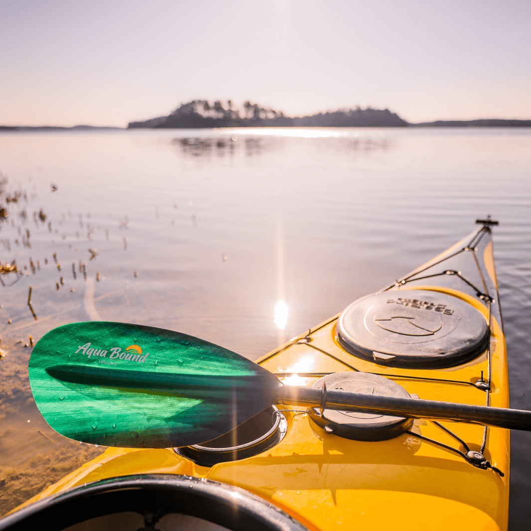Photo from Caj in Norway Green Tide Whiskey paddle across the bow of a yellow kayak#color_green-tide