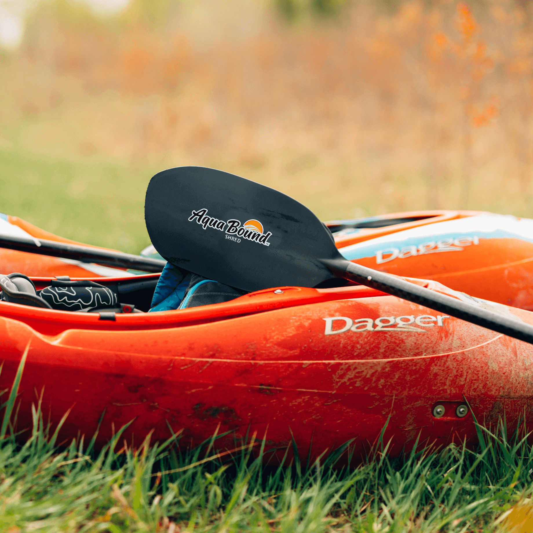 shred carbon whitewater kayak paddle laying on whitewater kayak 