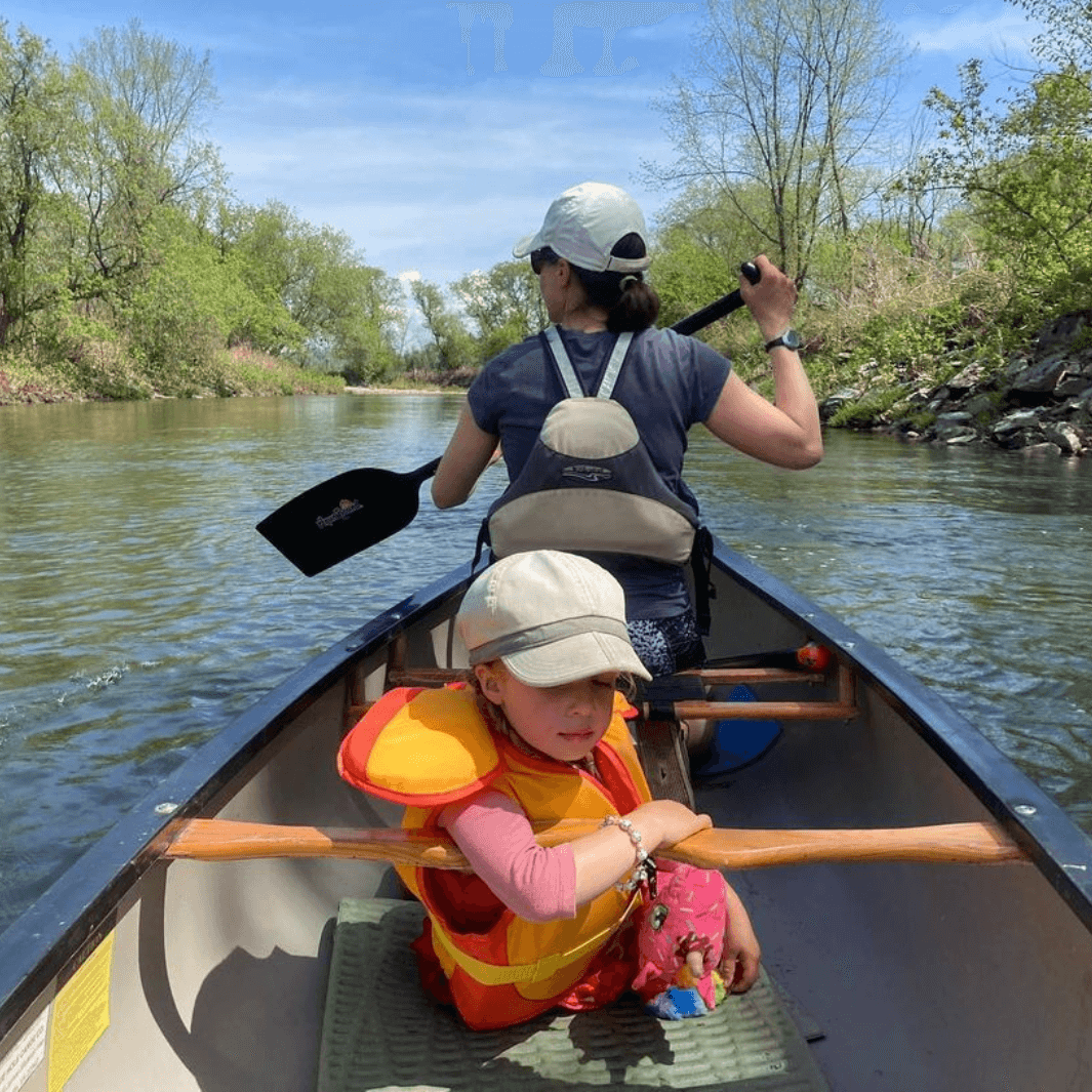 edge 1-piece canoe paddle being paddled in the bow with child sitting in middle of canoe