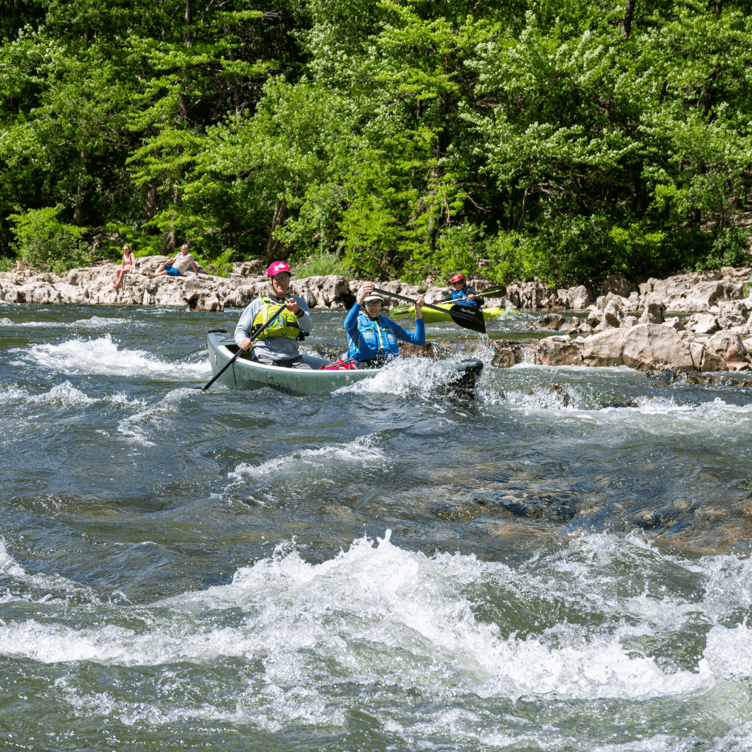 2 whitewater canoeists paddling with the edge 3-piece canoe paddle through small rapids