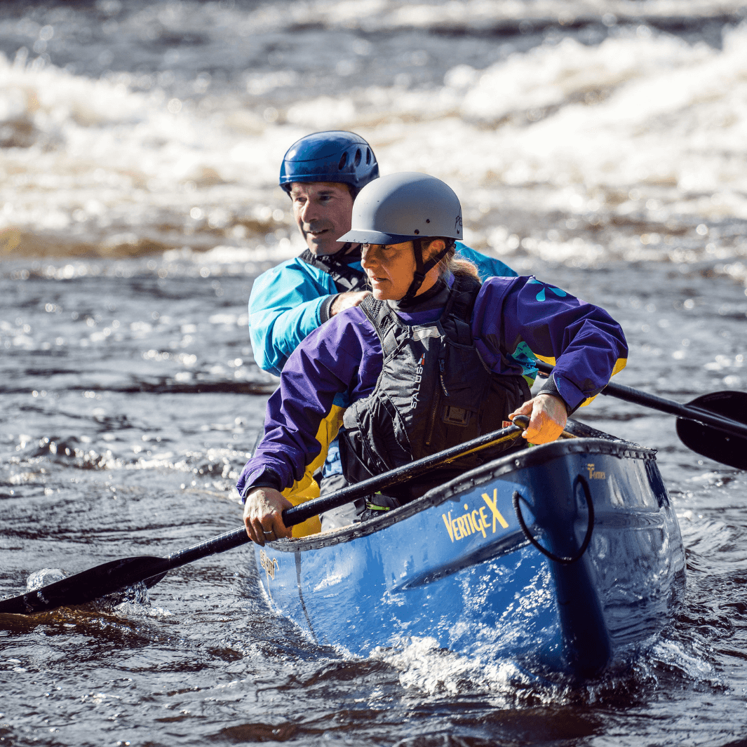 2 whitewater canoeists paddling with the edge 3-piece canoe paddle through rapids