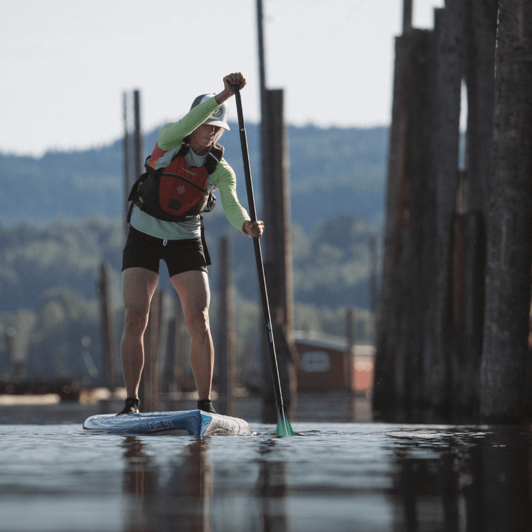 woman aggressively paddling with Malta green tide SUP paddle#color_green-tide