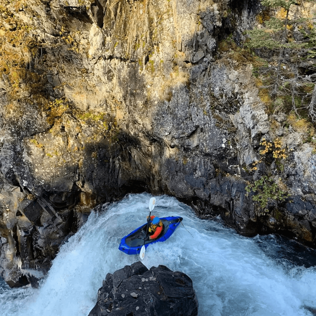 whitewater packrafter using the shred hybrid 1-piece around a curve