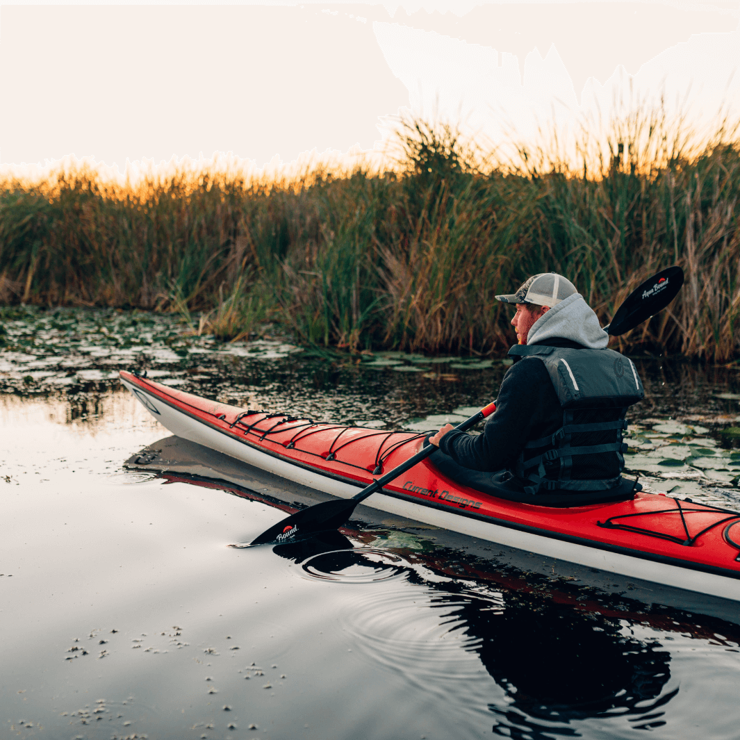 sting ray carbon 2-piece posi-lok being paddled by man in red kayak 