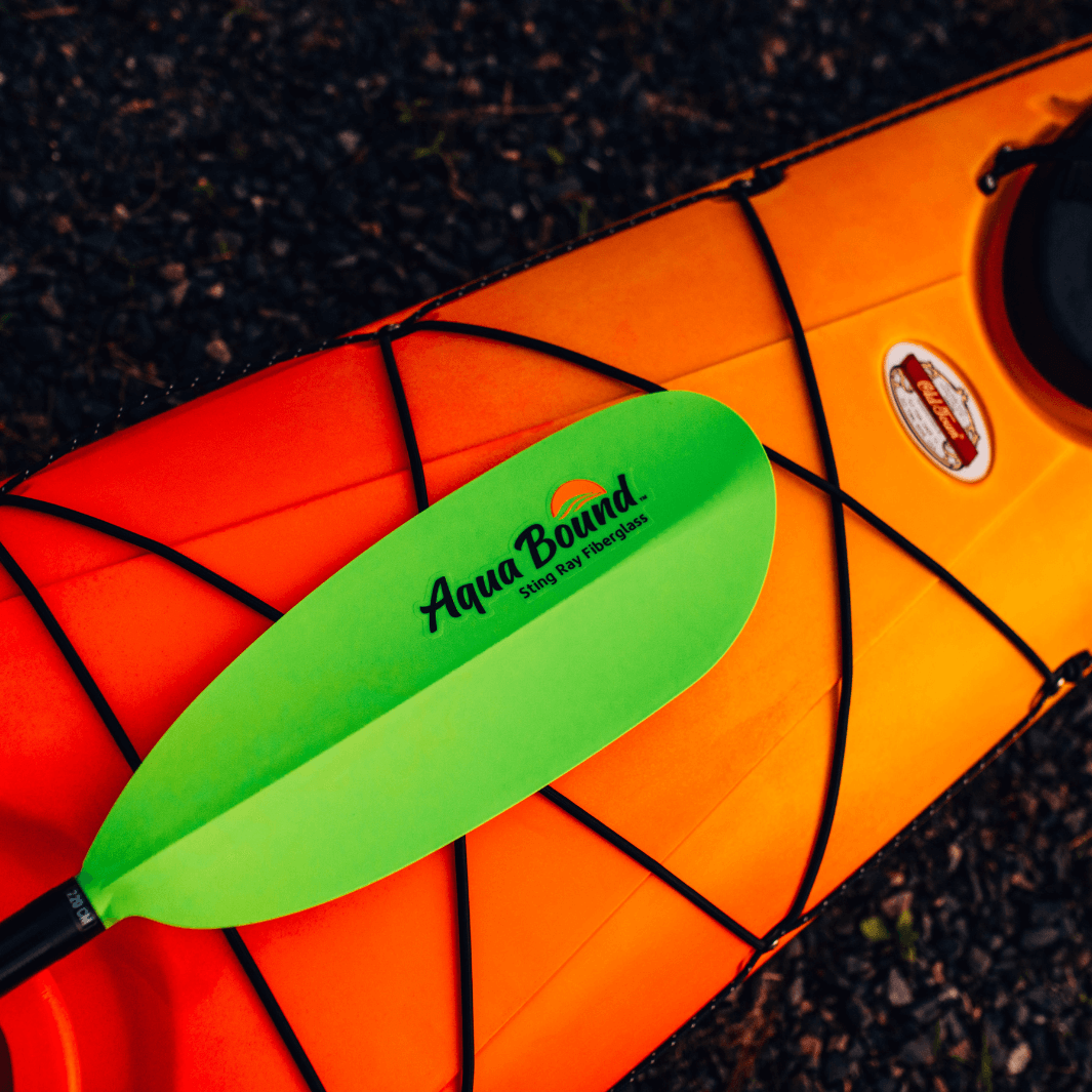 sting ray fiberglass 2-piece snap button electric green close up on orange and yeloow kayak bow#color_electric-green