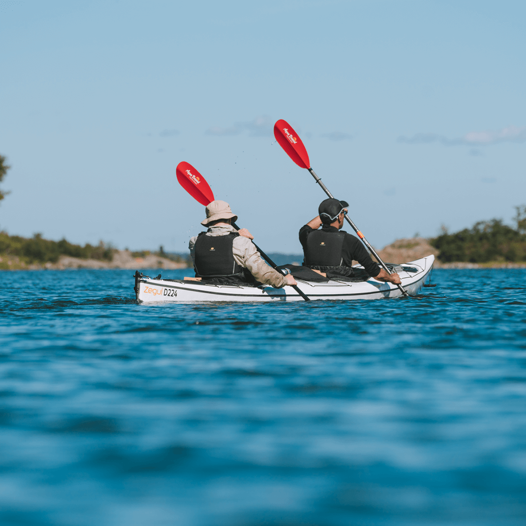sting ray hybrid 2-piece posi-lok sunset red being paddled in tandem kayak#color_sunset-red