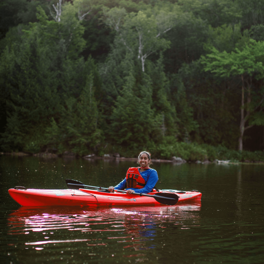 tango carbon 2-piece posi-lok kayak paddle being paddled in red kayak by female kayaker