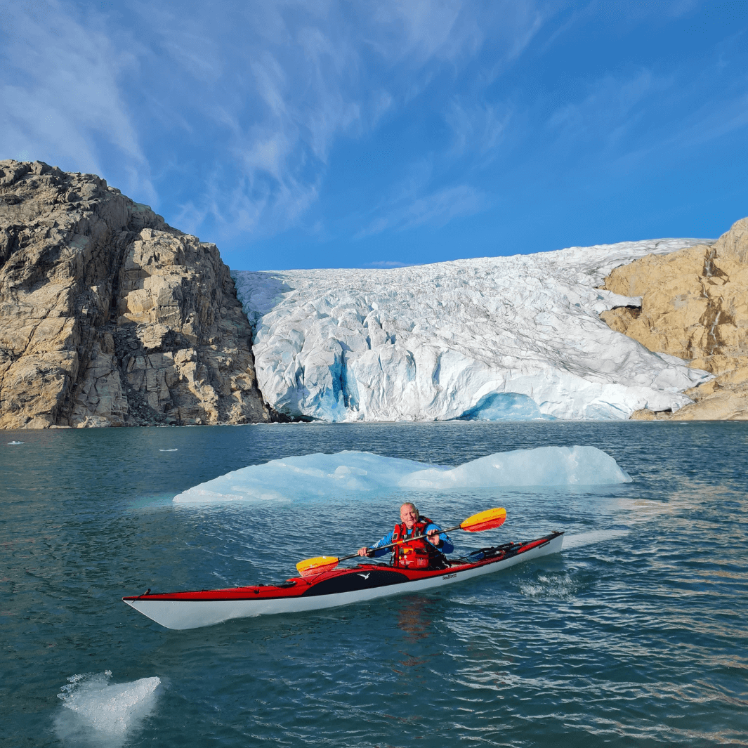 tango fiberglass bent shaft kayak paddle fuego being paddled in glacial waters in Norway#color_fuego